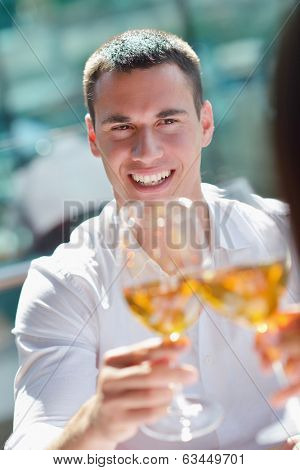 happy young couple having lanch at beautiful restaurant on by the sea on  beach