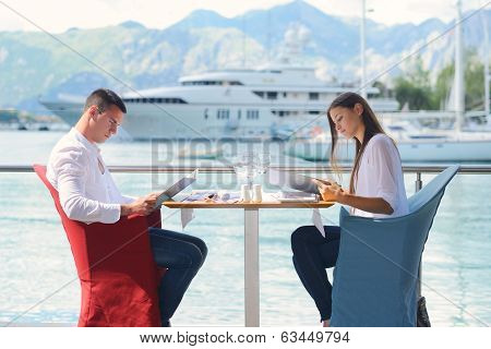 happy young couple having lanch at beautiful restaurant on by the sea on  beach