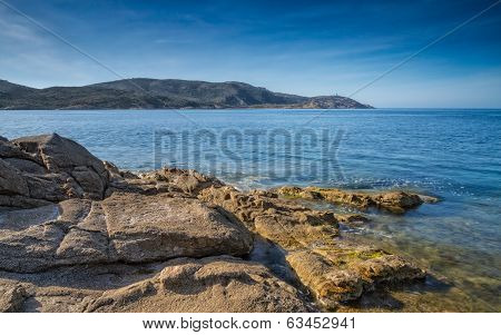 Rocks And Sea Overlooking La Revellata Lighthouse In Corsica
