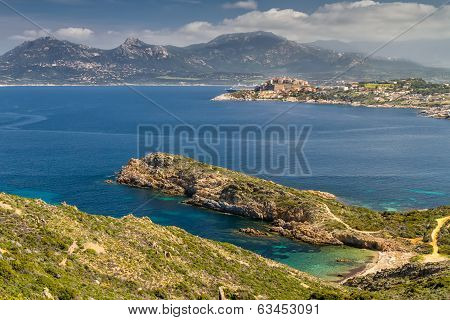 The Citadel Of Calvi With A Deserted Beach And Turquiose Sea