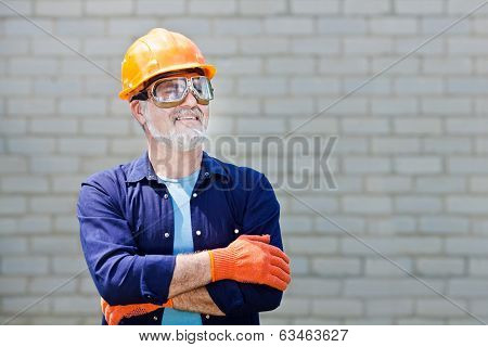 Portrait Of Happy Seniorman With Hard Hat Posing With Crossed Arms