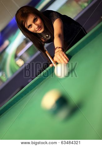 Young brunette girl playing snooker
