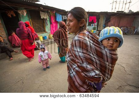 KATHMANDU, NEPAL - DEC 19, 2013: Unidentified local children near their homes in a poor area of the city. The caste system is still intact today but the rules are not as rigid as they were in the past