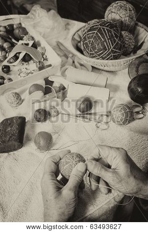 Old male sewing