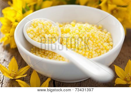 spa with yellow herbal bath pearls and flowers 