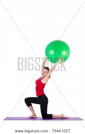 Young woman exercising with swiss ball