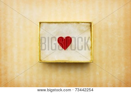 Gift of love. hearty gift. A golden box with an red heart inside. 