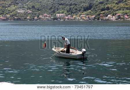 PERAST, MONTENEGRO - JUNE, 08: fishermen in a boat watching their nets, Perast, Montenegro, on June 08, 2012