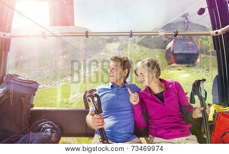 Senior hikers in cableway