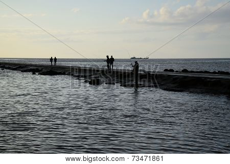 Fisher's silhouettes at pier