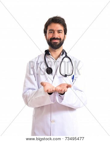 Doctor Holding Something Over White Background