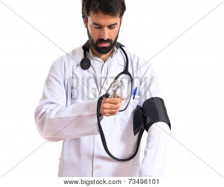 Doctor With Blood Pressure Monitor Over White Background