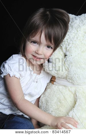 a little girl with bear on a black background