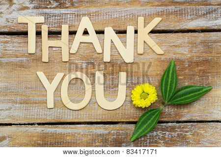 Thank you written with wooden letters and Santini flower on rustic wood