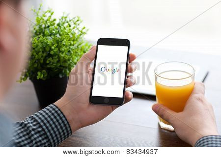 Man Holding iPhone 6 With Google On The Screen