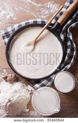 Bechamel Sauce In A Pan And Flour, Milk On The Table Top View
