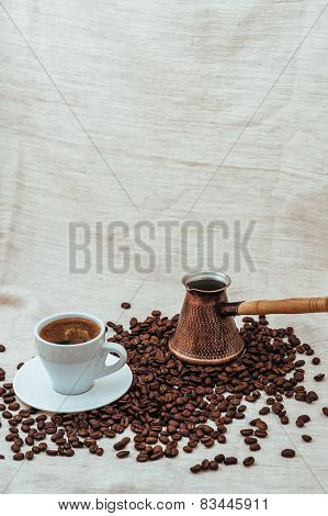 Coffee turk and cup of coffee on burlap background. coffee beans isolated on white background. roast