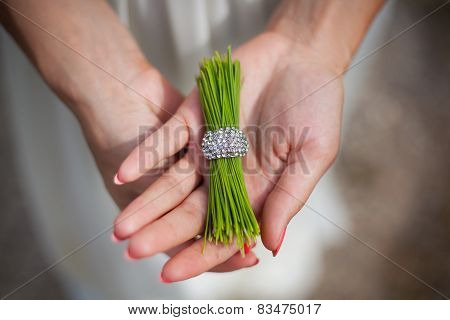 pine needles with a ring in the hands of girl