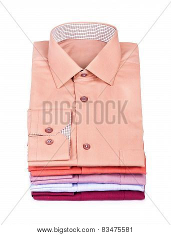 Stacks Of Many Colored Clothes Isolated On A White Background