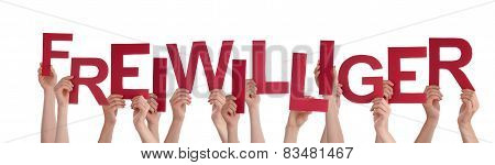 People Holding Red German Word Freiwilliger Means Volunteer