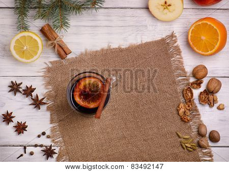 Mulled wine, punch and spices for glintwine on wooden background