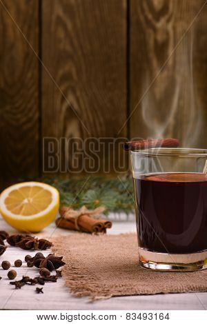 Mulled wine, punch and spices for glintwine on wooden background