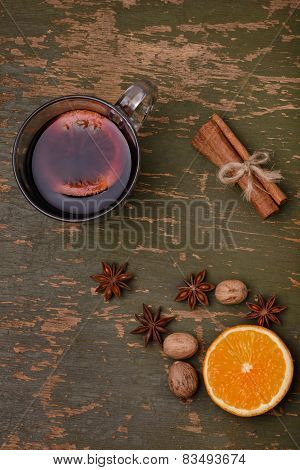Mulled wine, punch and spices for glintwine on wooden background