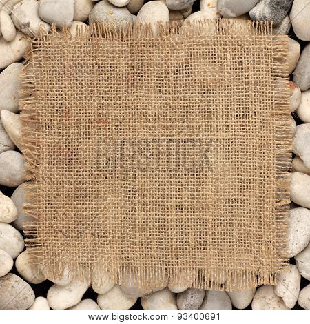 Texture Of  Burlap Square On River Rock
