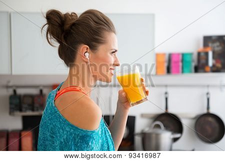 Closeup Of Fit Woman In Profile Starting To Drink Smoothie