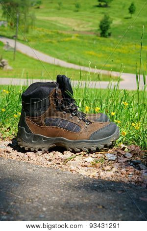 Hiking Boots Stand On The Wayside