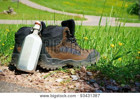 Hiking Boots In Front Of A Summer Meadow