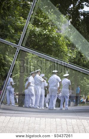 NEW YORK - MAY 22 2015: Reflections of US Navy sailors in the glass of the the National September 11 Museum as they gather for the military re-enlistment and promotion ceremony during Fleet Week 2015.