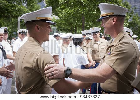 NEW YORK - MAY 22 2015: A US Marine Corpsman is congratulated by a senior officer after the promotion ceremony at the National September 11 Memorial site during Fleet Week 2015.