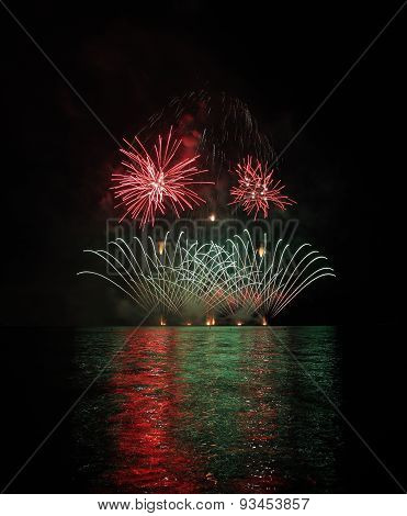 Colorful Fireworks With Reflection On Lake.