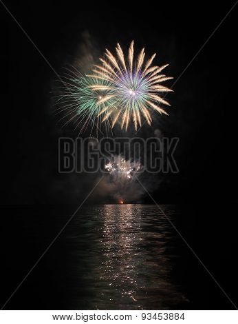 Colorful Fireworks With Reflection On Lake.