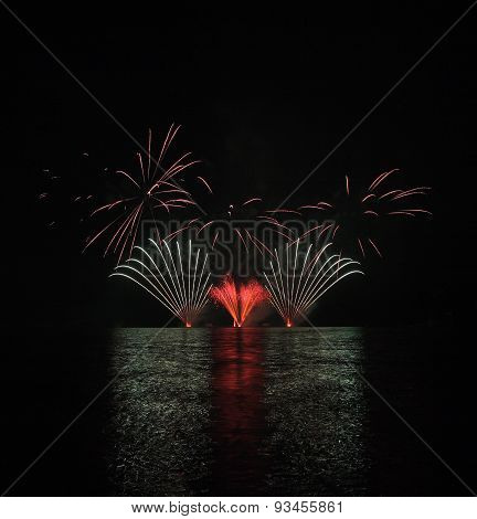 Colorful Fireworks With Reflection On Lake.