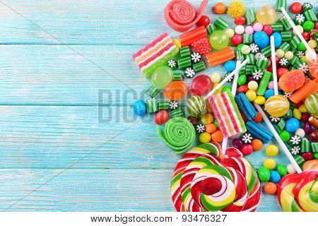 Colorful candies on wooden background