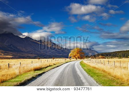 Mountain landscape with road and blue sky, Otago, New Zealand