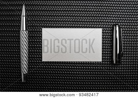 Luxurious rollerball pen on a carbon surface
