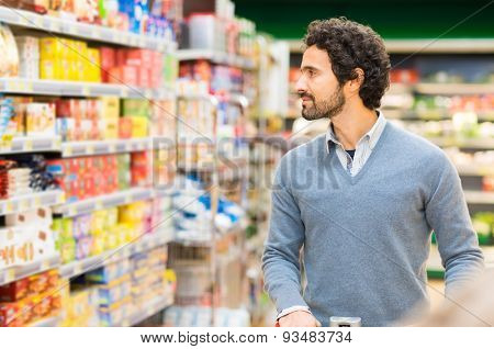 Man choosing the right product in a supermarket