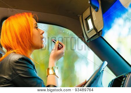 Girl Painting Her Lips Doing Makeup While Driving The Car.