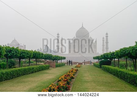 Agra, India - January 8, 2012: Taj Mahal view in morning fog from across the Mehtab Bagh or The Moonlight Garden Agra India