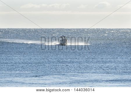 Cape Cod Canal Massachusetts USA - September 14 2014: Boat approaches Cape Cod Canal from windy choppy Cape Cod Bay