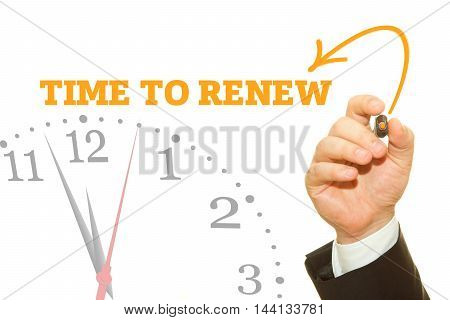 Businessman hand writing TIME TO RENEW message on a transparent wipe board.