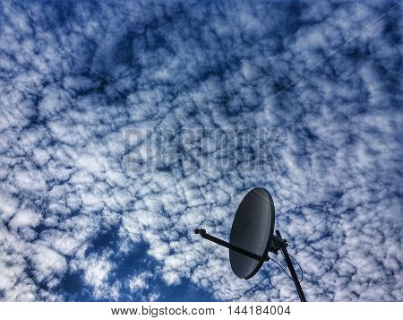 Satellite Dish on interestin cloudy sky background
