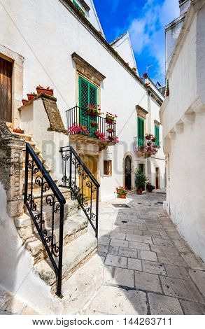 Locorotondo Italy. Medieval whitewashed street and houses in small city of Puglia Apulia Bari region.