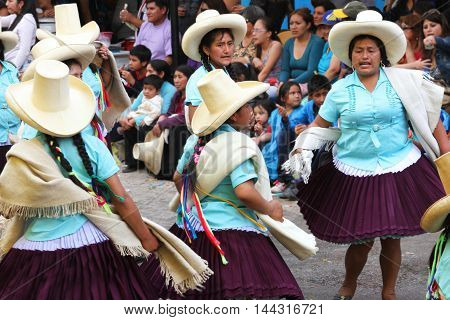 Cajamarca Peru - February 8 2016: Peruvian women in sombreros and traditional dresses dance in Carnival parade in Cajamarca Peru on February 8 2016