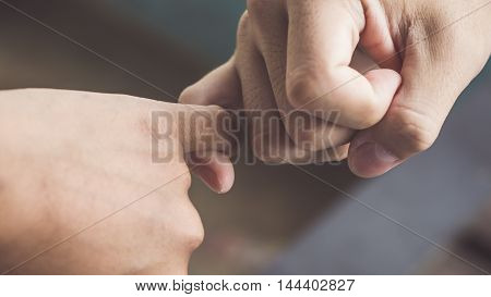 Depth of field, Vintage Style of Two hands hook each other's little finger concept of promise,heal