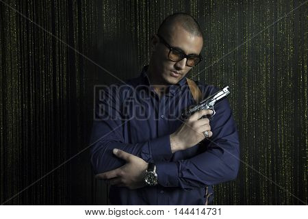Brutal strong man with a gun Caucasian appearance