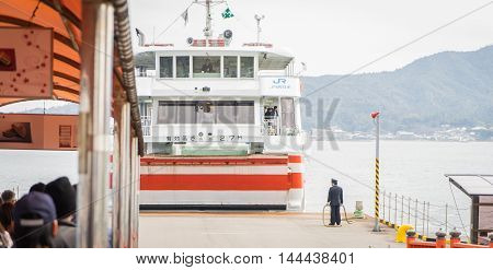Hiroshima, Japan - March 16, 2016: Miyajima on March 16, 2016. Tourists are waiting to board the JR Ferry to Miyajima.